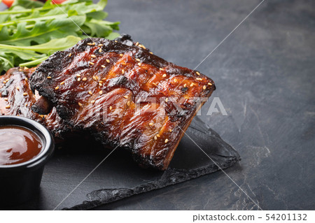 Closeup of pork ribs grilled with BBQ sauce. Closeup of pork ribs grilled with BBQ sauce. 54201132