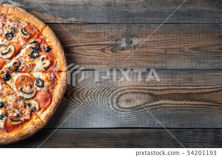 Tasty pepperoni pizza with mushrooms and olives. Tasty pepperoni pizza with mushrooms and olives. 54201193