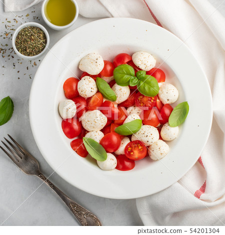 White plate of classic delicious caprese salad. White plate of classic delicious caprese salad. 54201304