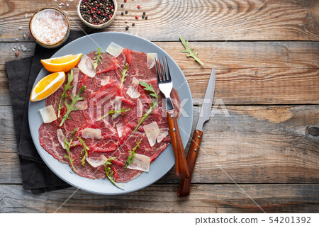 Marbled beef carpaccio with arugula. Marbled beef carpaccio with arugula. 54201392