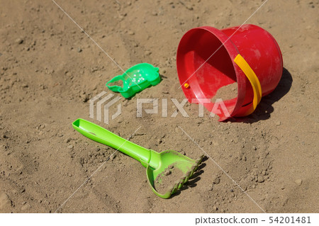 Childrens toys lying on the sand of the beach Childrens toys lying on the sand of the beach 54201481
