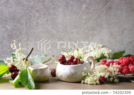 Fresh cherry and raspberry berries Fresh cherry and raspberry berries 54202309