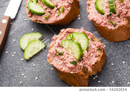 Sandwiches with chicken pate and cucumber on dark Sandwiches with chicken pate and cucumber on dark 54202654