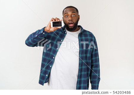 Handsome african american man isolated on grey background, presenting smart phone. Handsome african american man isolated on grey background, presenting smart phone. 54203486