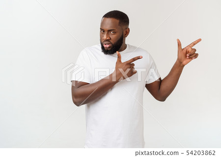 Young amazed African American pointing his finger at white background with copy space for your Young amazed African American pointing his finger at white background with copy space for your 54203862