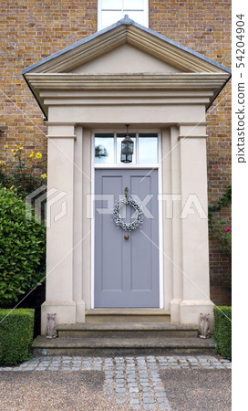 Elegant wooden grey doors with hanging wreath 54204904