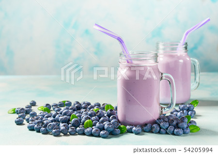 Glass jar mugs with blueberry smoothie Glass jar mugs with blueberry smoothie 54205994