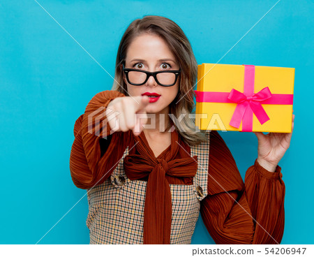 Young  woman with yellow gift box 54206947
