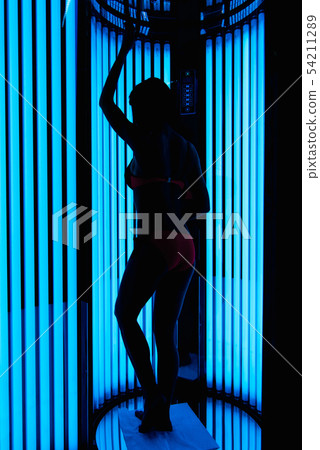 silhouette of a tanned slender girl in a Solarium silhouette of a tanned slender girl in a Solarium 54211289