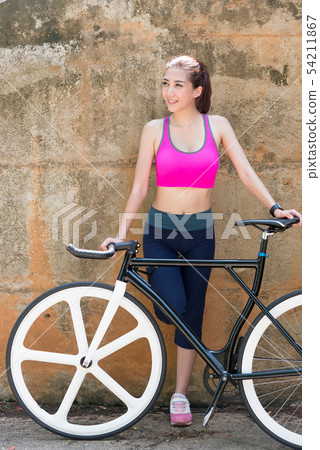 Young Asian woman with a bike. 54211867