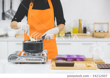 Woman making chocolate Woman making chocolate 54212007
