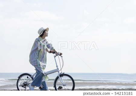 Woman blue sky relax cycling 54213181