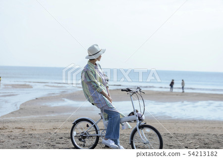 Woman blue sky relax cycling 54213182