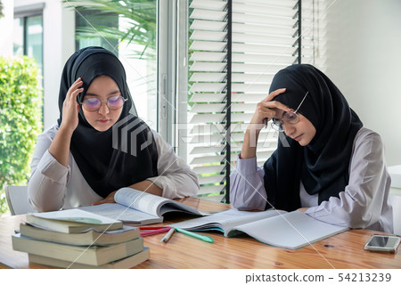 Young muslim students in traditional clothes Young muslim students in traditional clothes 54213239