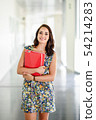 Young adult student woman in a hallway of her 54214283
