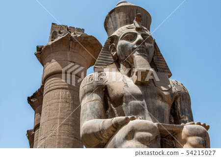 Egypt Luxor Temple. granite Statue of Ramesses II seated in front of columns Egypt Luxor Temple. granite Statue of Ramesses II seated in front of columns 54215027