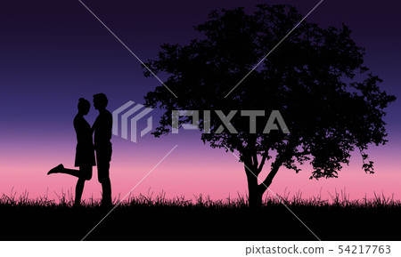Loving young man and woman embracing on grass at 54217763