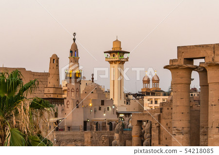 catholic Church and Muslim Mosque Tower religion Symbols together in Luxor temple at sunset catholic Church and Muslim Mosque Tower religion Symbols together in Luxor temple at sunset 54218085