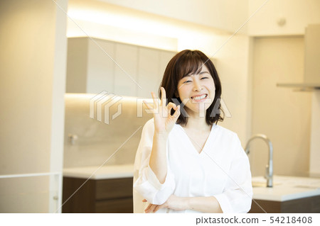 A woman standing in the kitchen 54218408