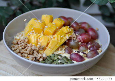 smoothie bowl, mango yogurt with fruit topping 54220273