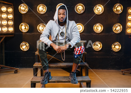 Black rapper in hoodie sitting on the steps 54222935