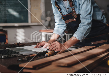 Carpenter working with equipment on wooden table 54224134