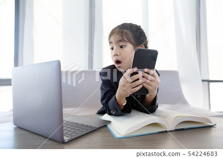 asian kid in business use laptop and mobile as 54224683
