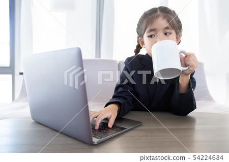 asian kid in business use laptop and mobile as asian kid in business use laptop and mobile as 54224684