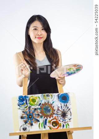 Artist holding painting palette and brush Artist holding painting palette and brush 54225039