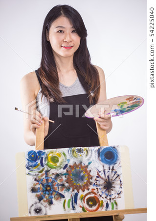 Artist holding painting palette and brush Artist holding painting palette and brush 54225040
