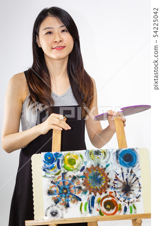 Artist holding painting palette and brush 54225042