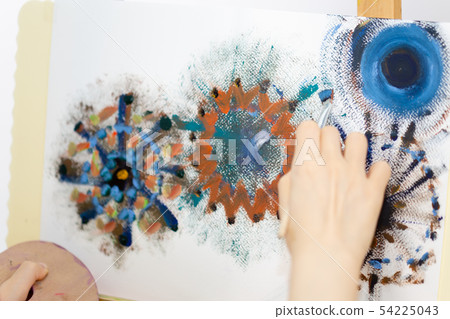 Artist painting on an easel Artist painting on an easel 54225043
