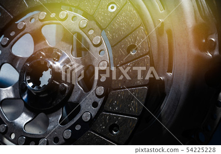 Close-up shot of clutch disk and basket on dark background Close-up shot of clutch disk and basket on dark background 54225228