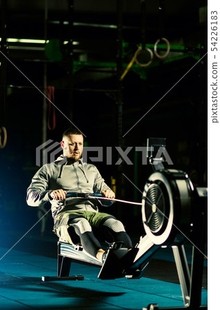 Workout on the rowing machines at the gym 54226183
