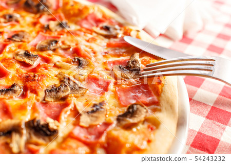 Pizza with ham and mushrooms. Delicious hot food sliced and served on white platter. Menu photo 54243232