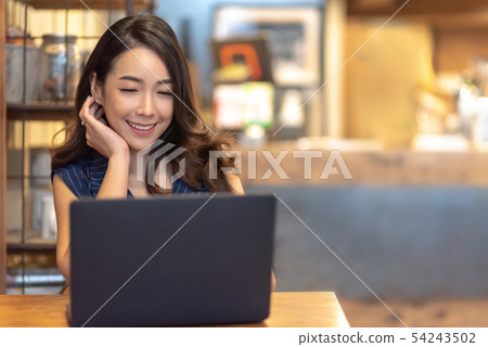 Woman making video call with laptop computer at 54243502