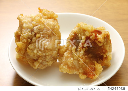 Fried chicken thighs on a small plate. 54243986