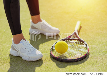 racket tennis, ball and sport sneakers on court racket tennis, ball and sport sneakers on court 54244983