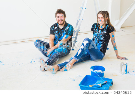 Renovation, redecoration and people concept - young couple doing a renovation in new home and have 54245635