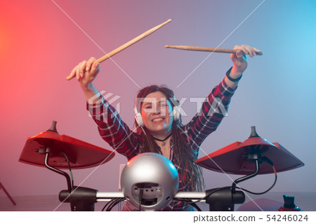Music and hobby concept - woman drummer playing the electronic drum set Music and hobby concept - woman drummer playing the electronic drum set 54246024
