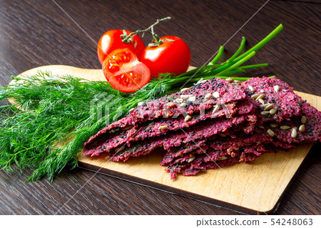 Beetroot vegan dry bread loaves, tomatoes and dill 54248063