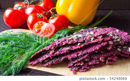 Vegan food. Beetroot dry bread loaves, tomatoes, 54248069