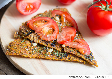 Dry diet crisp breads with sliced tomato on it 54248093