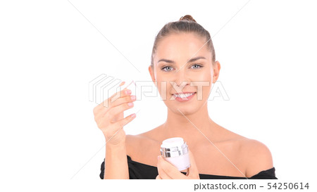 Beauty concept. Woman is opening a cream jar in Beauty concept. Woman is opening a cream jar in 54250614