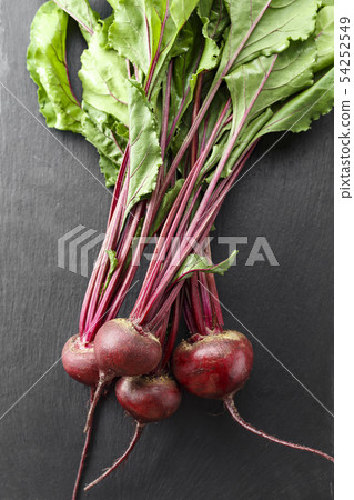 Beet, beetroot bunch on black stone background. Beet, beetroot bunch on black stone background. 54252549