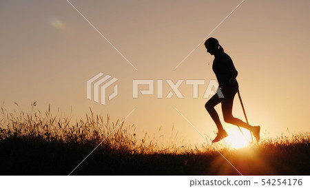 Silhouette of a woman - jumping through the rope at sunset Silhouette of a woman - jumping through the rope at sunset 54254176
