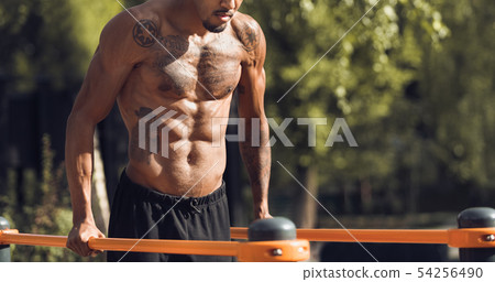 Fit Man Workout Arms On Parallel Bars, Training Triceps 54256490