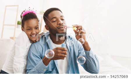 Play With Father. Dad And Daughter Blowing Soap Bubbles 54257069