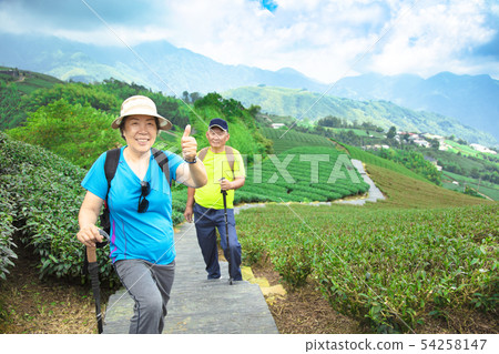 happy asian senior couple hiking in the nature happy asian senior couple hiking in the nature 54258147