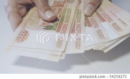 Womens hands count Russian money in denominations of 5000 Womens hands count Russian money in denominations of 5000 54258271